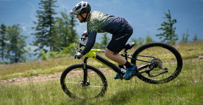 Ein Mann fährt mit einem Fahrrad über eine Wiese